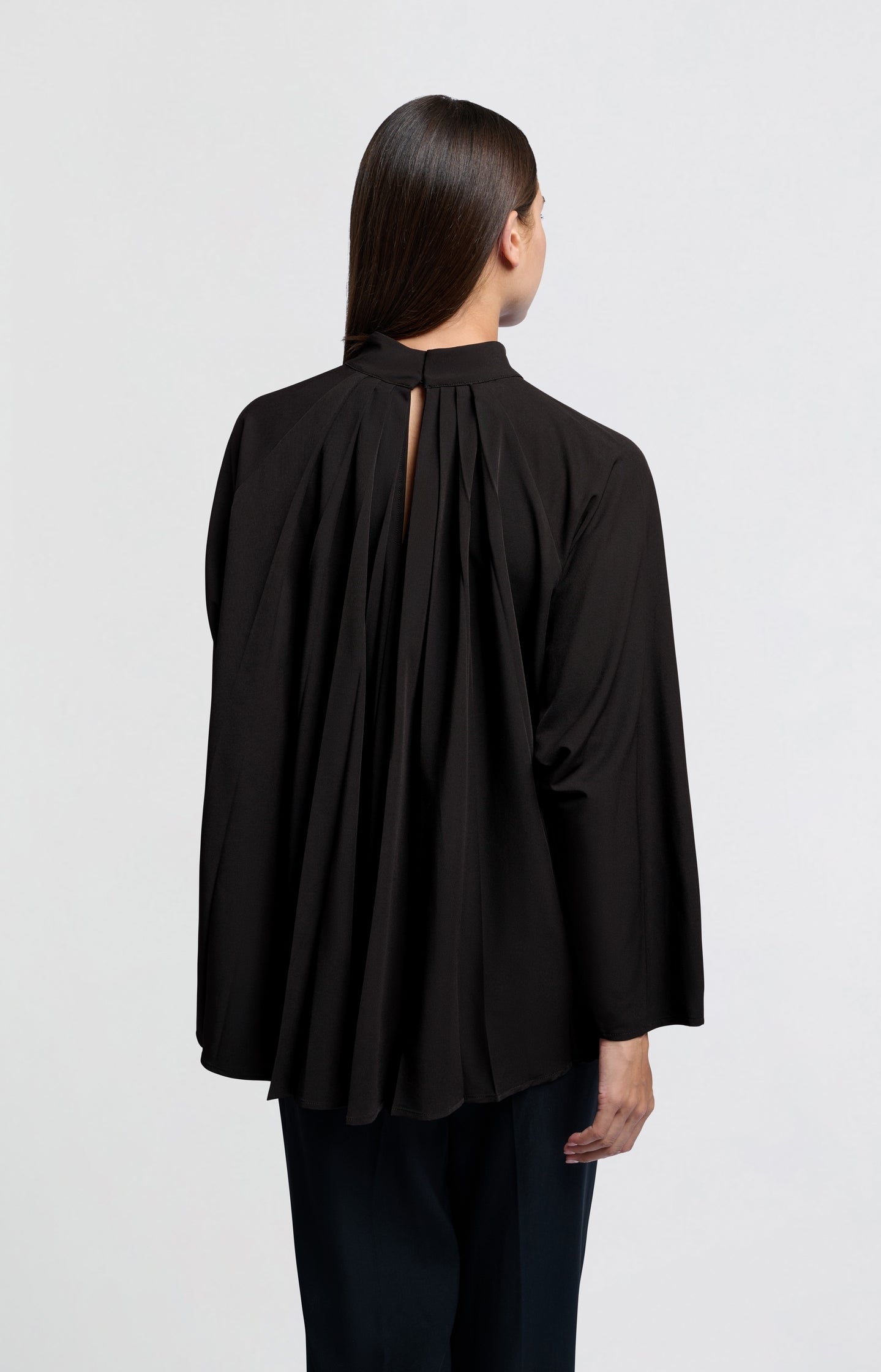 Black top with pleated details and turtleneck