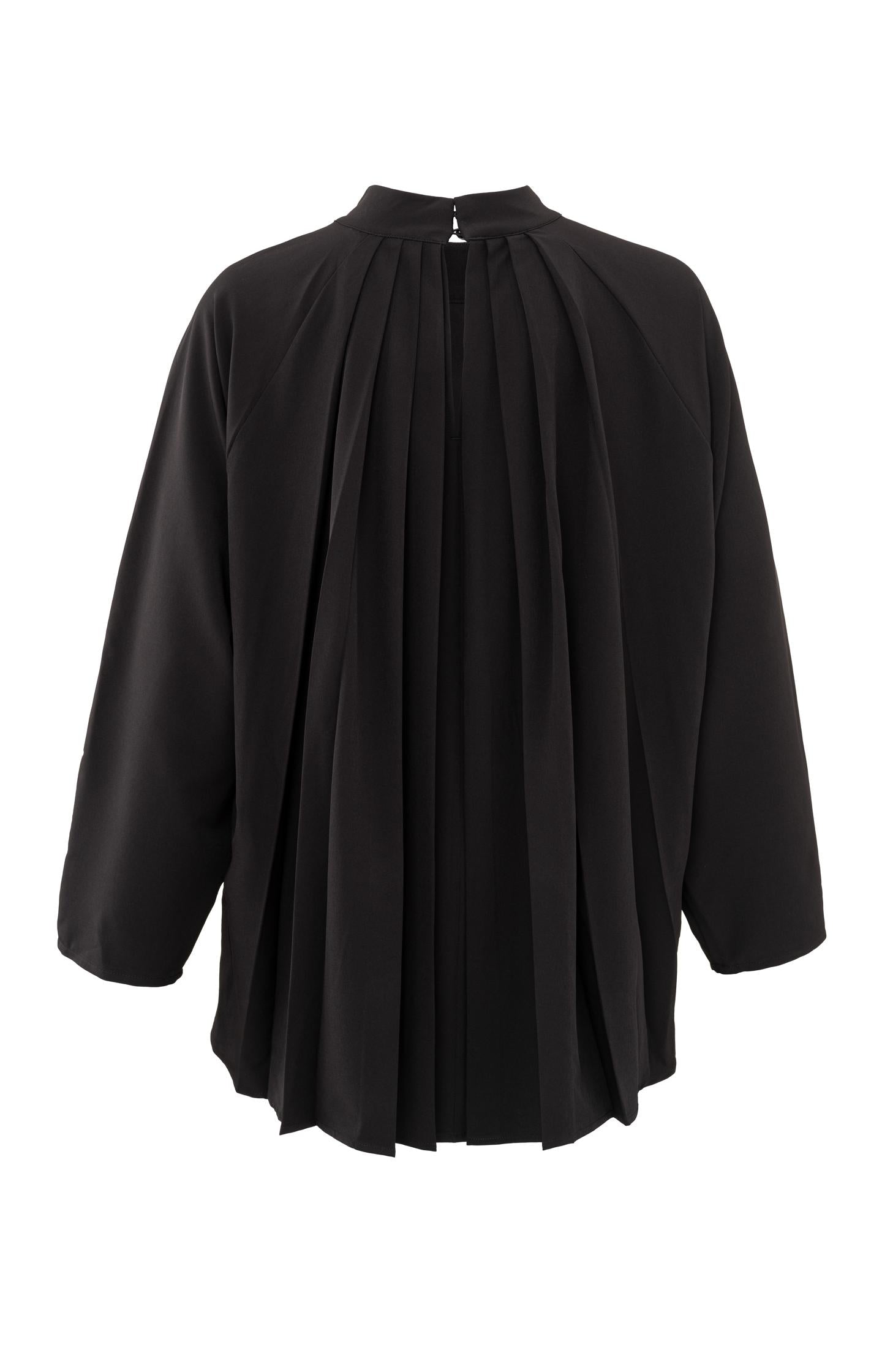 Black top with pleated details and turtleneck