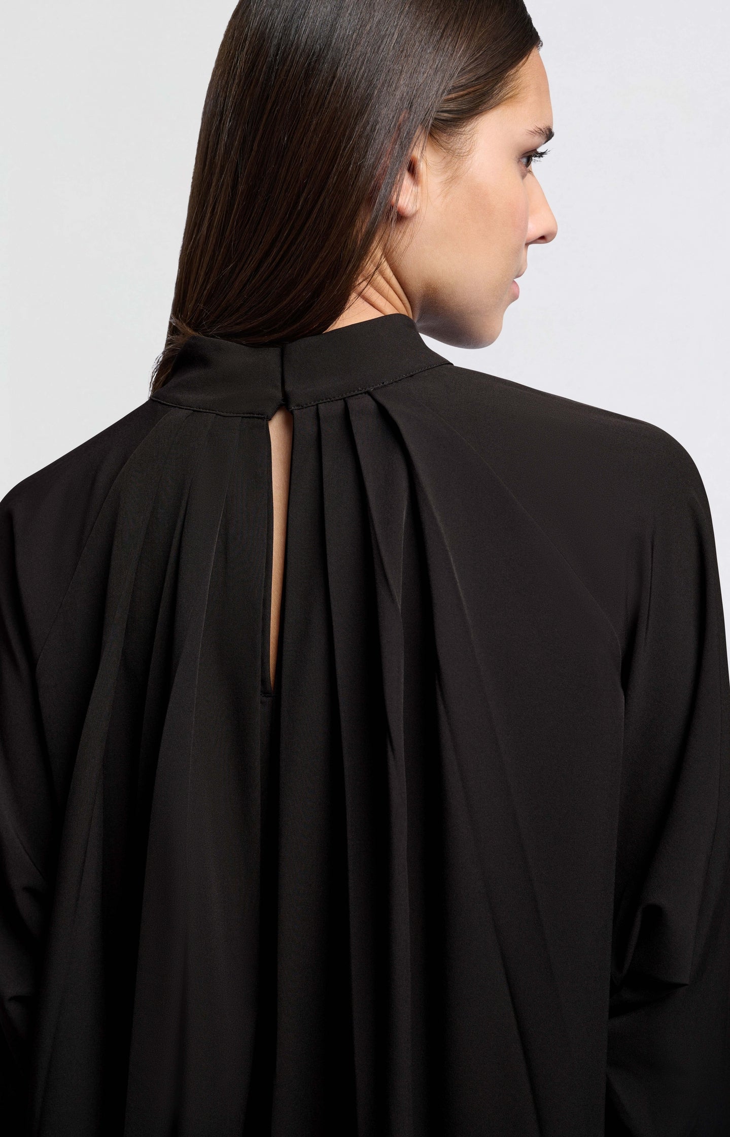 Black top with pleated details and turtleneck