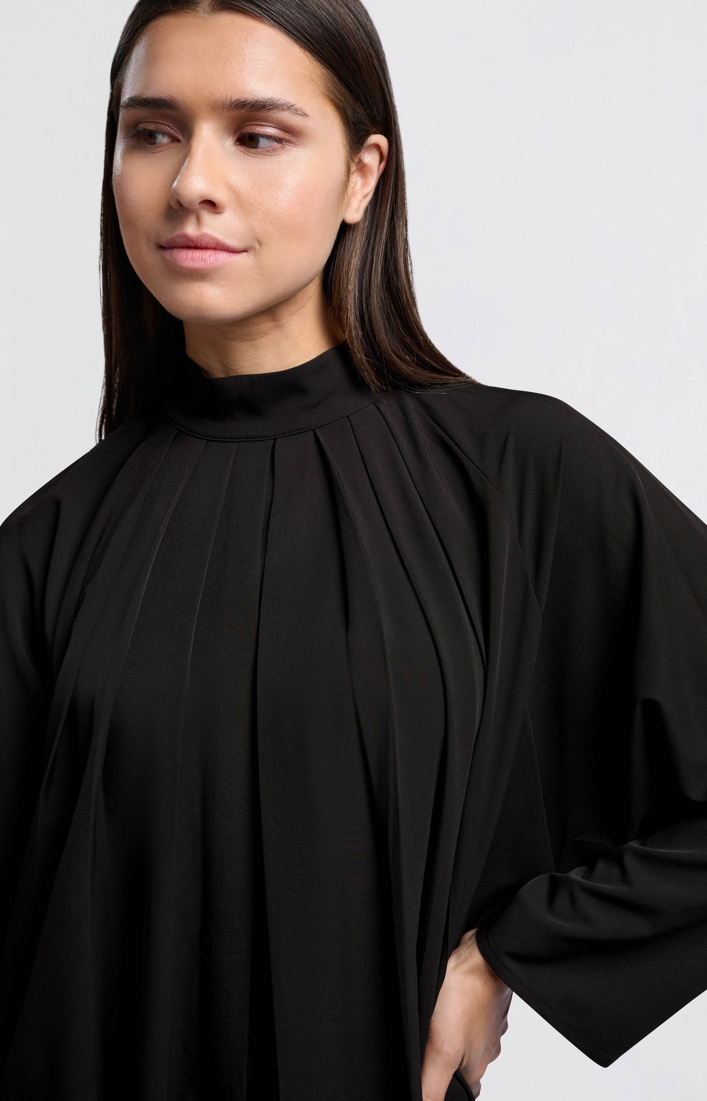 Black top with pleated details and turtleneck